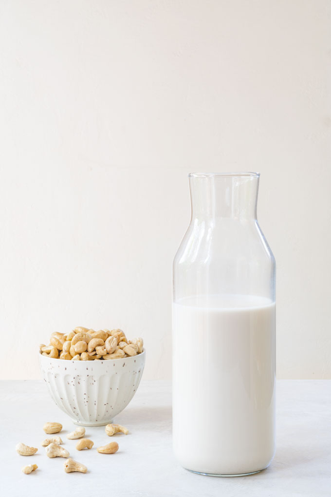 homemade cashew milk in a glass bottle